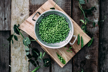 Fresh green peas in a plate. Peas in a pod. Country style
