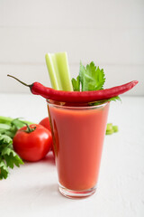 Composition with glass of bloody mary cocktail and ingredients on table