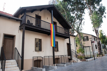 House facade windows decorated with the LGBT rainbow flag, gay pride