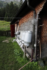old empty milk cans at an alpine hut in Switzerland 