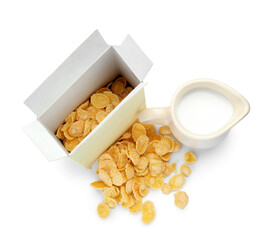 Box with tasty cornflakes and jug of milk on white background