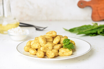 Plate with tasty pesto gnocchi on table