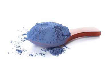 Spoon with powdered blue matcha tea on white background