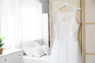 Fototapeta premium Beautiful wedding dress in bedroom