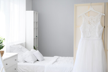 Beautiful wedding dress in bedroom