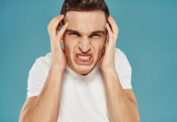 angry man with displeased facial expression in white t-shirt