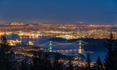 Vancouver city downtown panorama in night. Vancouver Harbour marina aerial view. Lions Gate Bridge, British Columbia, Canada.