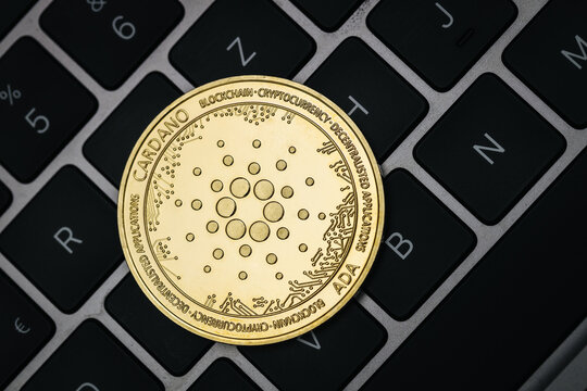 Cardano Ada cryptocurrency coin close-up on a keyboard.