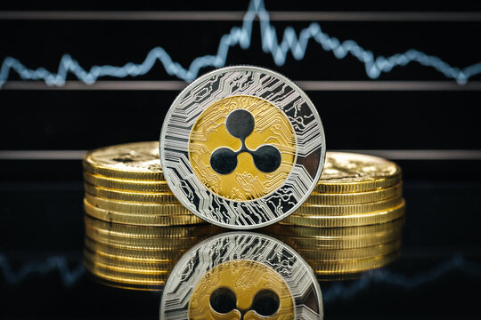 Ripple XRP cryptocurrency, physical close-up, in front of a price chart
