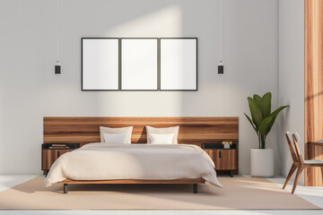 Three posters and wood bed in modern white bedroom