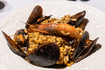 Seafood paellas, traditional Spanish Mediterranean cuisine. Rice with mussels, prawns and squid