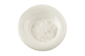 Crystals of coarse sea salt in a white plate. Healthy foods from nature. Isolated on white background. Close-up. Top view.