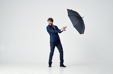 man in a suit holding an umbrella over his head rain protection professional