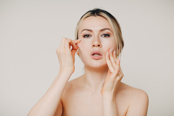 Young adult doing facial gymnastics self massage and rejuvenating exercises face building and...