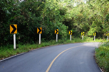 Yellow Sign warning of the curve road on the mountain in Thailand