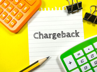 Business concept.Text Chargeback writing on notepaper with pencil,calculator and paper clips on yellow background. - obrazy, fototapety, plakaty