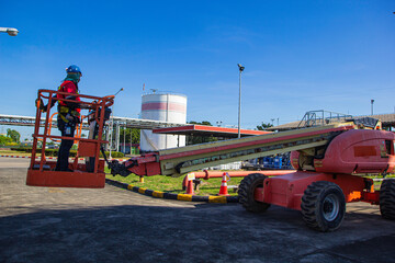 Male control boom lift in a industry working at high