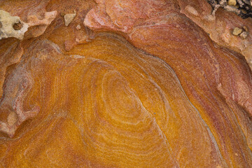 Close up of orange coloured textured rock. No people, copy space, background.