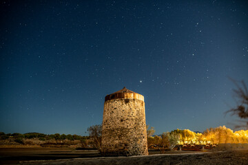 panoramic view of the ancient mills at night against the background of the starry sky on the island...
