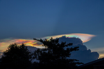 Beautiful iridescent cloud, Irisation. Skyscraper background.