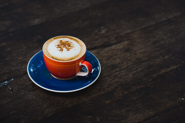 Cup cappuccino on wooden table.