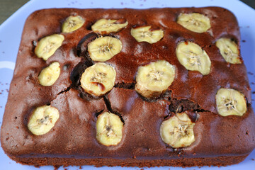 Mouthwatering Homemade Wholemeal Chocolate Banana Cake on a Blue Plate