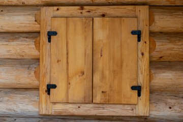 Closed wooden window of a new wooden house