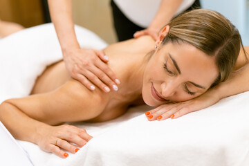 Obraz na płótnie Canvas Middle-aged woman having a back massage in a beauty salon.