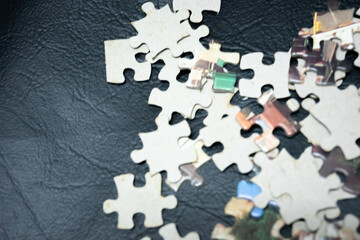 jigsaw puzzle on wooden background. to represent how complexity in game and challenge. plan and goal as concept.	