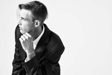 man in suit pensive look posing fashion hairstyle