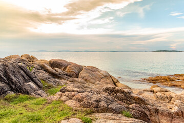 Nature in twilight period which including of sunrise over the sea and the nice beach. Summer beach with blue water and purple sky at the sunset.	
