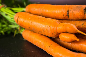Bunch of carrots on the wooden table. Gardening summer bio concept.