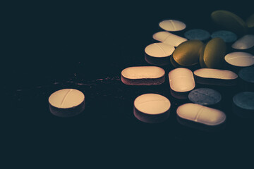 Pharmaceutical medicine pills in both tablets and capsules with the vintage retro picture style. Pharmacy theme and treatment medication as concept.	