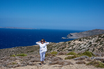 woman tourist on the background of blue sky and beautiful views of the island of Crete 