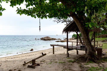 Nature in twilight period which including of sunrise over the sea and the nice beach. Summer beach with blue water and purple sky at the sunset.	
