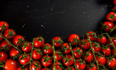 Tomatoes on wood background. Close-up of bio fresh vegetables. Group of summer tomatoes. Space for...