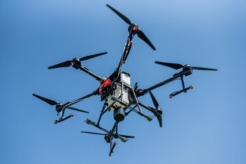 Professional agriculture drone flying in the blue sky