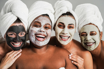 Multigenerational women having fun wearing face beauty mask for skin care therapy - Main focus on...