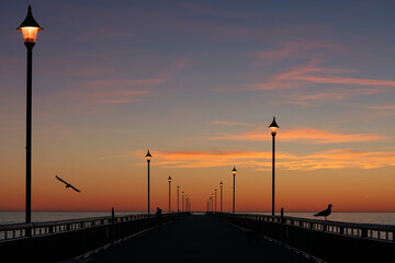Colorful sunrise at New Brighton Pier, Christchurch, New Zealand - obrazy, fototapety, plakaty