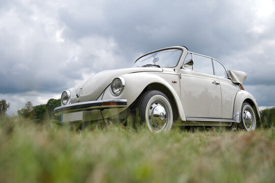 HOLESOV, CZECH REPUBLIC - AUGUST 29, 2021: White VW Beetle 1303 cabriolet low angle view. VW beetle is an economy car that was manufactured by Volkswagen from 1938 until 2003.