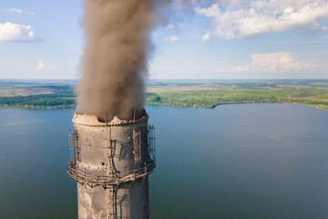 Aerial view of coal power plant high pipes with black smokestack polluting atmosphere. Electricity...