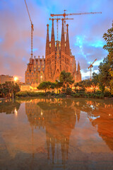 The Sagrada Familia at dusk reflected in the water, Barcelona, Spain