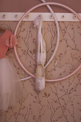 The interior of a children's girly room. Hoop and pink ballet flats hanging on the wall