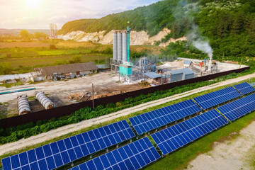 Aerial view of electrical power plant with rows of solar photovoltaic panels for producing clean ecological electric energy at industrial area. Renewable electricity with zero emission concept.