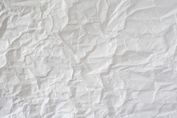 Crumpled white paper as background.