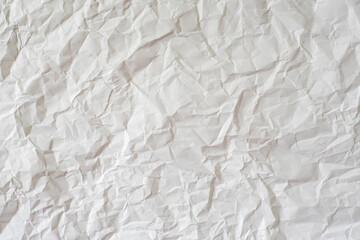 Crumpled white paper as background.