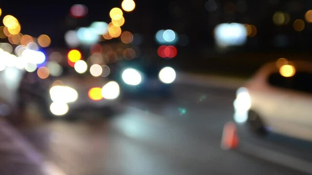 Blurred blue and red lights on patrol car. Police lights flash at night. Crime scene. Car accident and traffic jam. 