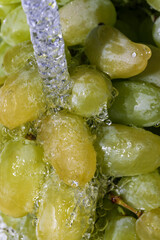 White grapes under a stream of water