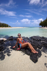 Woman on the rocks at Ile aux Cerfs, Mauritius