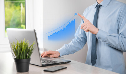 Business man holding tablet and showing holographic graphs and stock market statistics gain profits. Concept of growth planning and business strategy. Display of good economy form digital screen.